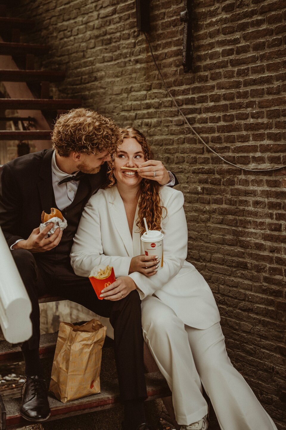 een man en een vrouw die op de treden van een gebouw zitten